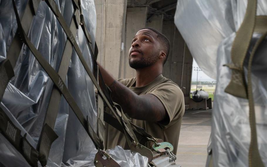 U.S. Air Force Senior Airman Taylon Stokes, 18th Logistics Readiness Squadron Ground Transportation support operator, secures cargo following a Ground Transportation cargo movement at Kadena Air Base.